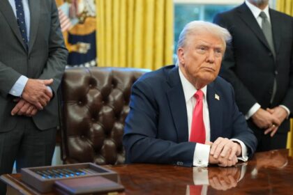 President Trump sitting at desk in Oval Office