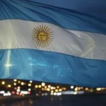 una bandera de argentina bajo el cielo nocturno de buenos aires
