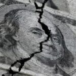 Cracked US dollar bill symbolizing dollar collapse